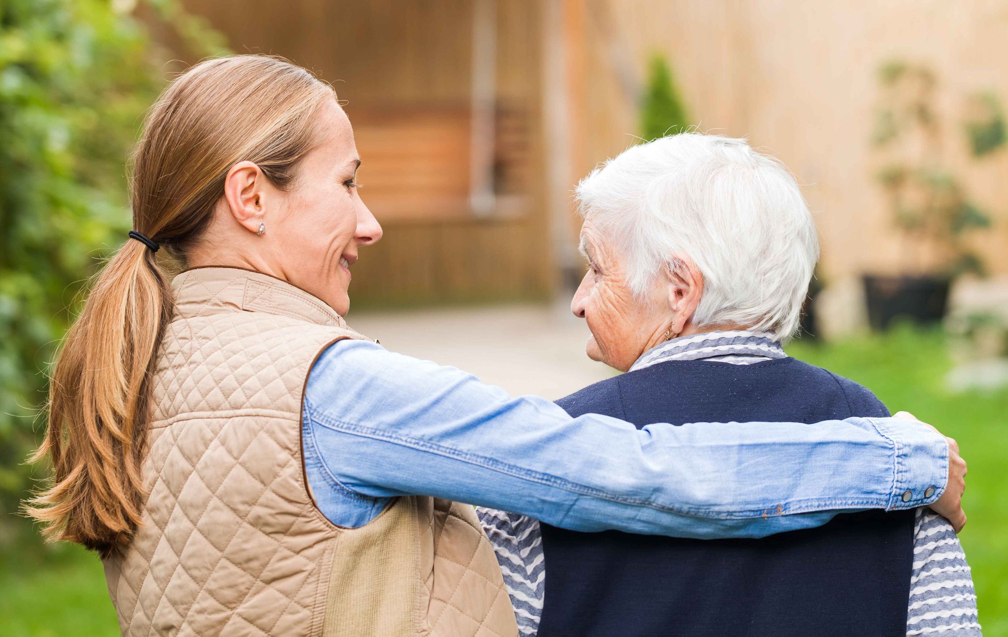 Woman with arm around elderly woman