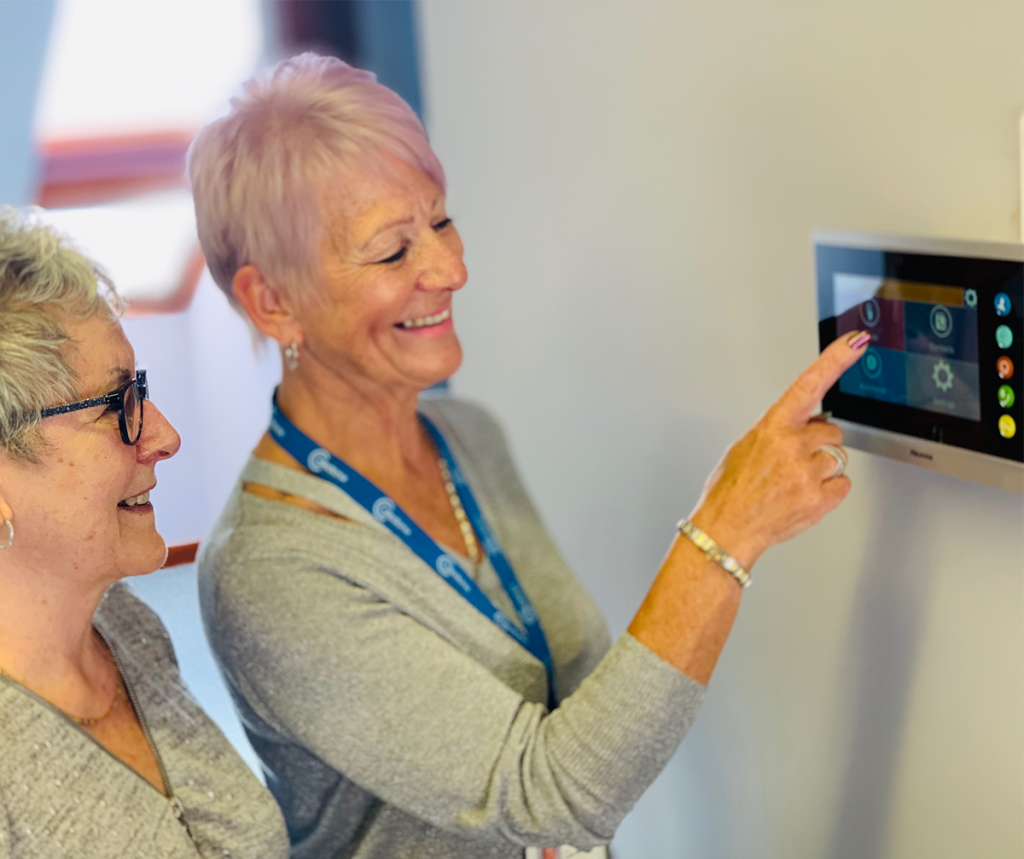 Two women using Appello Smart Living Solutions device