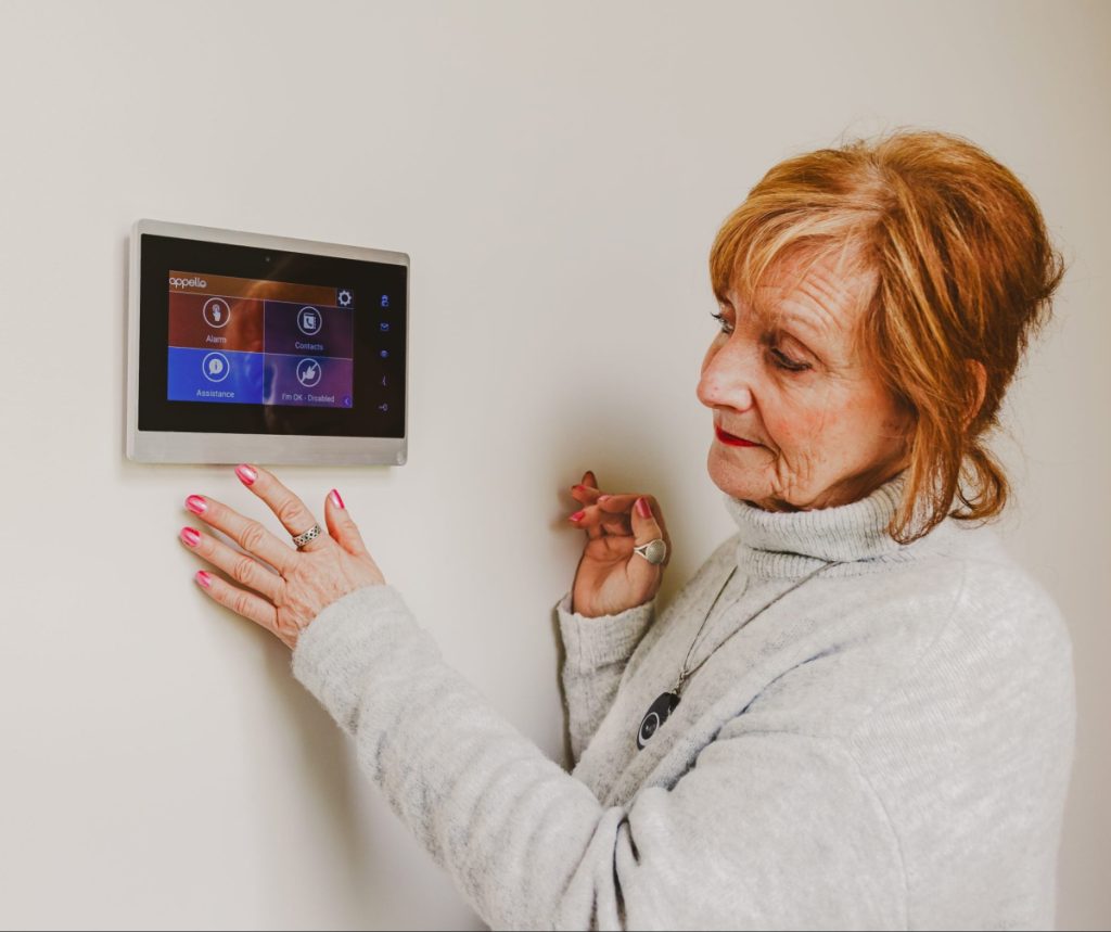 Woman using warden call system, Smart Living Solutions System